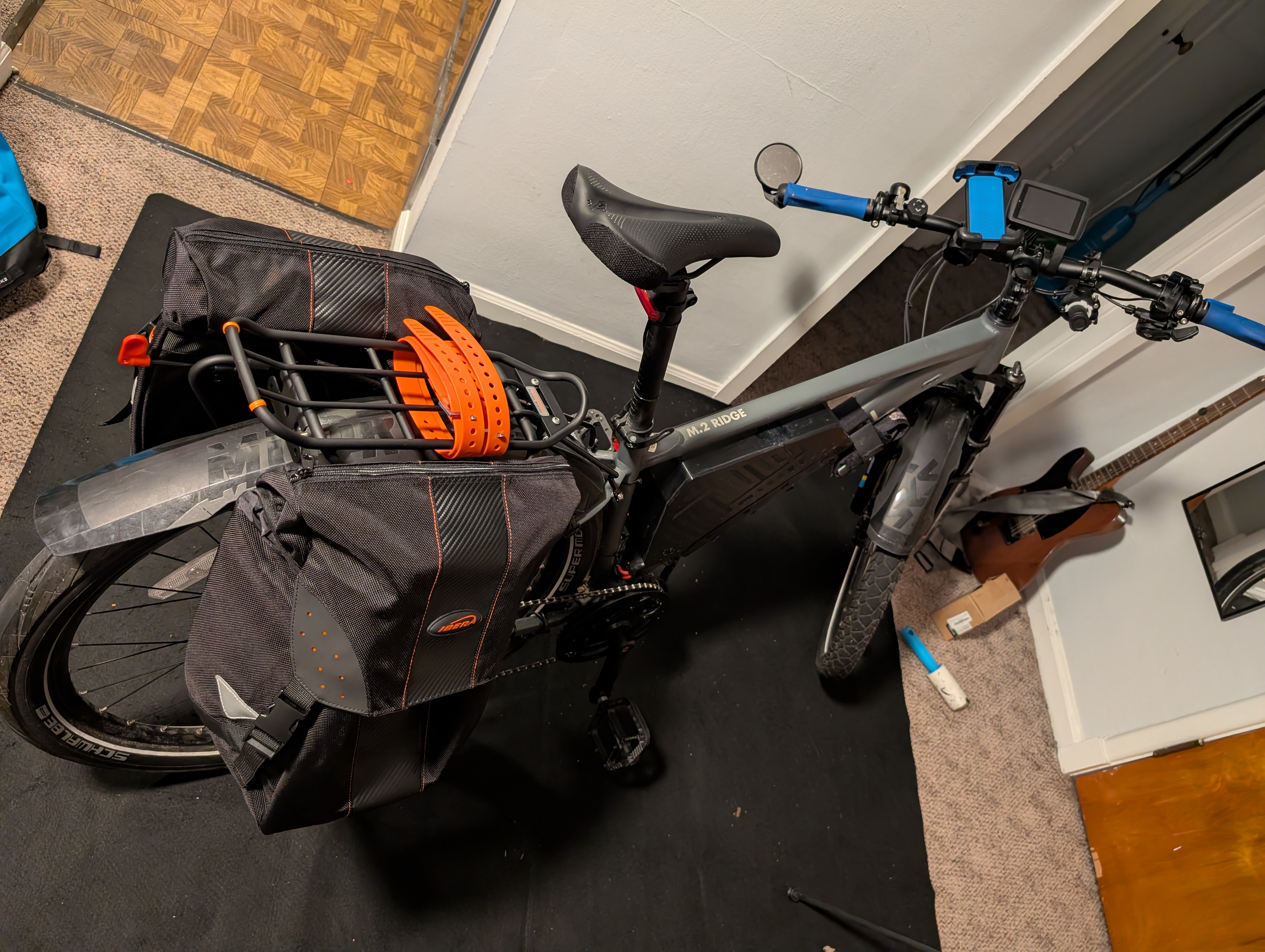 Bicycle inside of a house with rear rack and bags installed