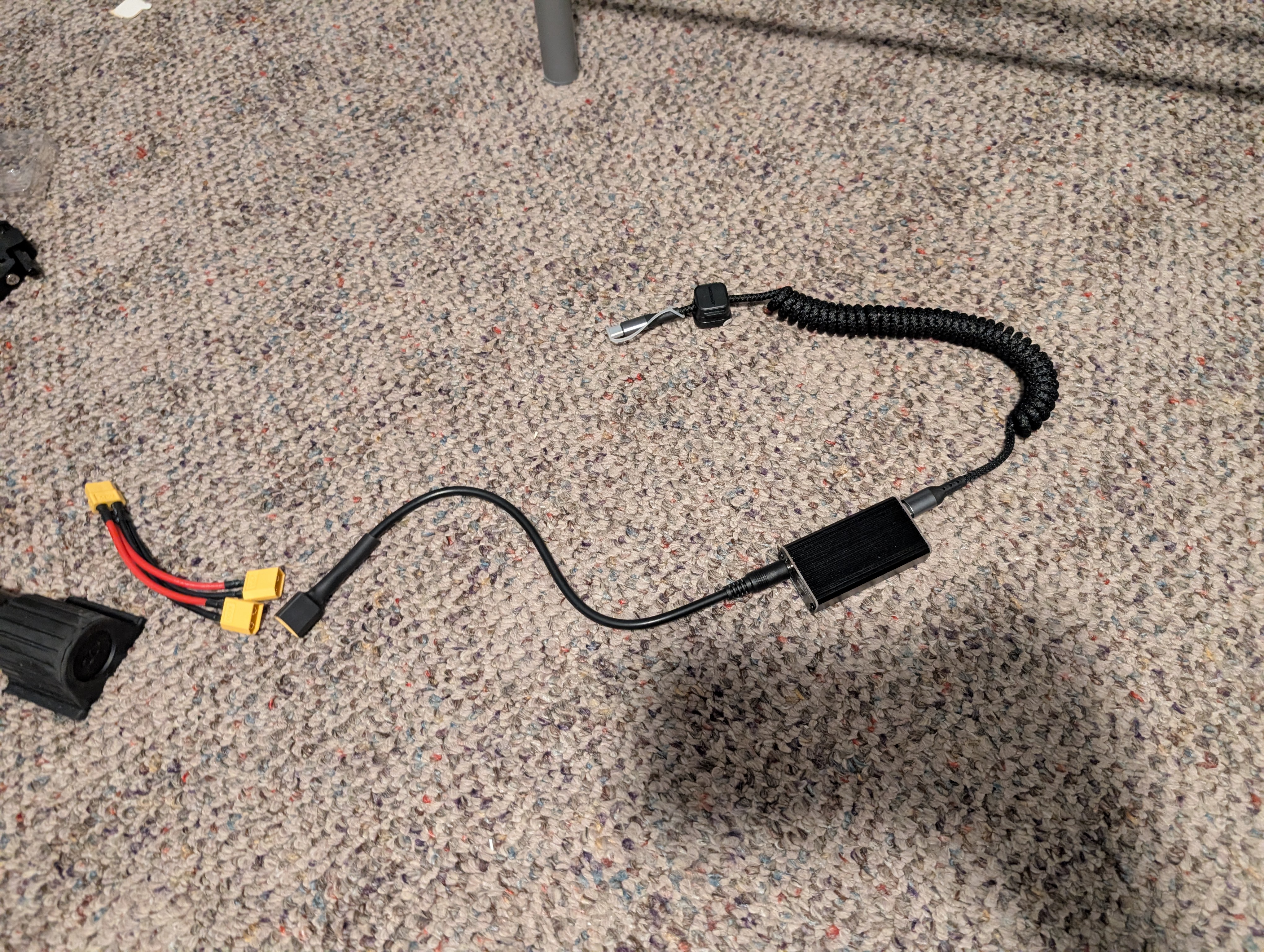 A mockup of the phone charging setup on the floor, the cables are in order