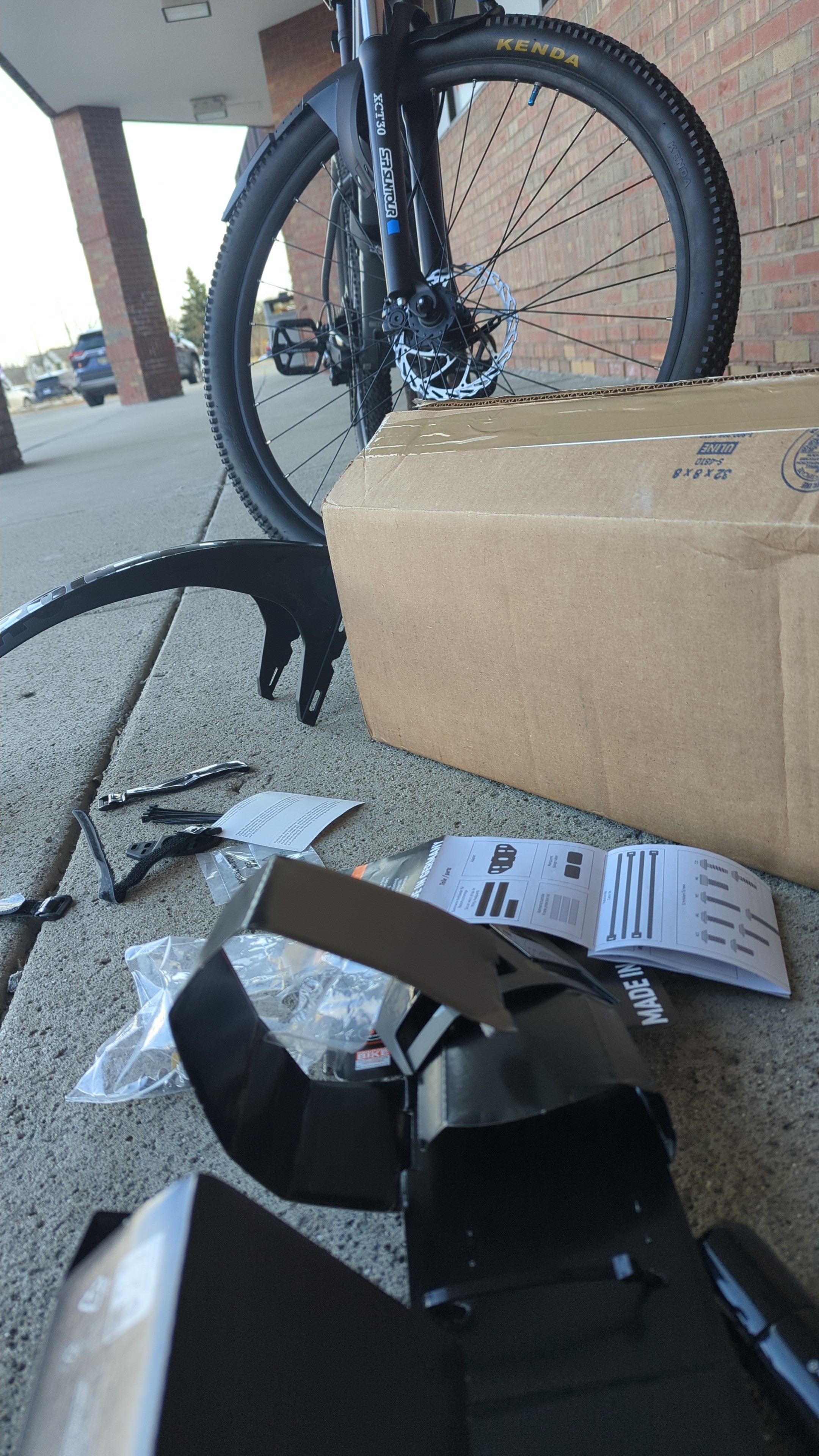 Perspective from the ground of fenders on the floor in front of bicycle